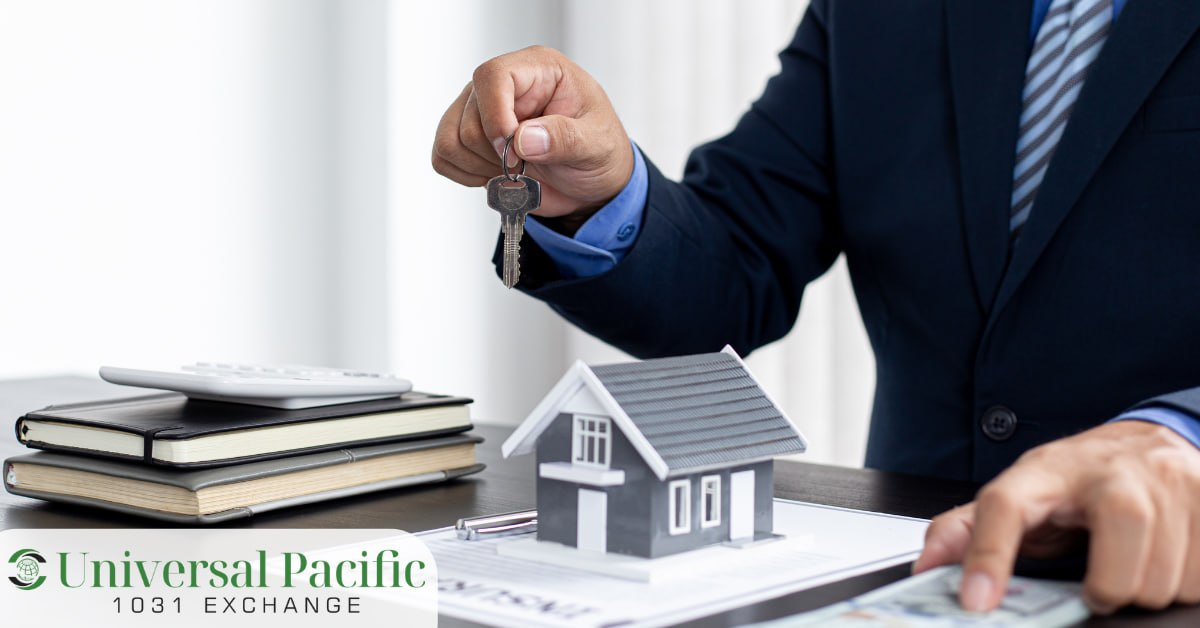 Real estate professional handing over keys beside a model house, calculator, and cash