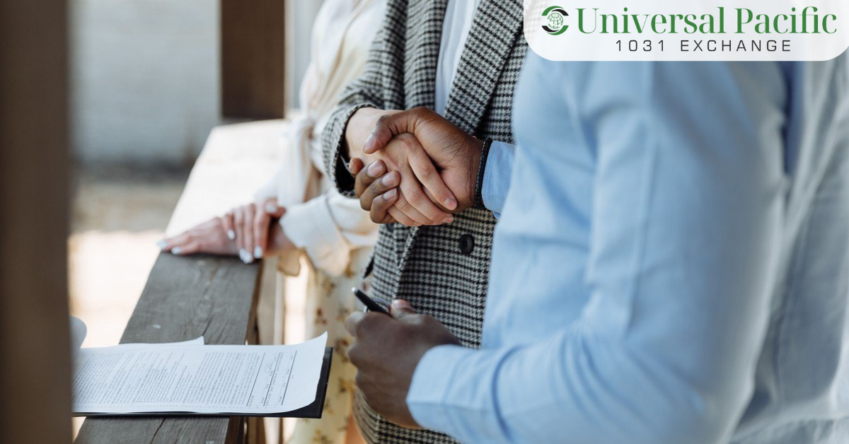Investor shaking hands with a qualified intermediary over a signed 1031 exchange agreement