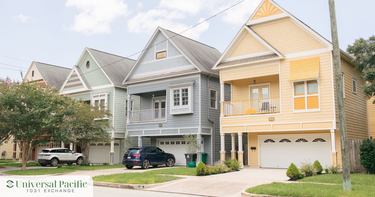 A row of colorful two-story Texas homes on a sunny residential street