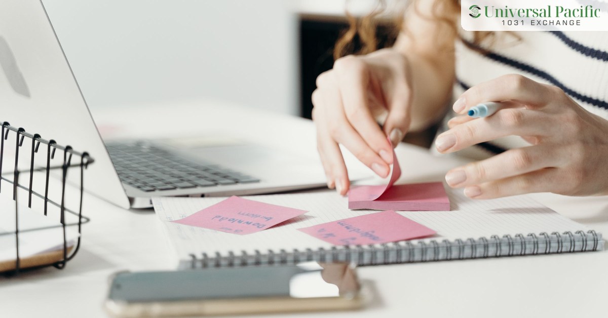 Investor planning a 1031 exchange with notes, a laptop and a calendar