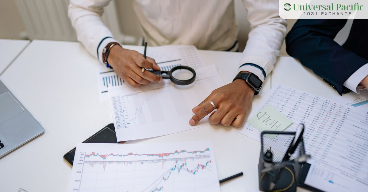Professionals comparing financial charts and figures on a desk