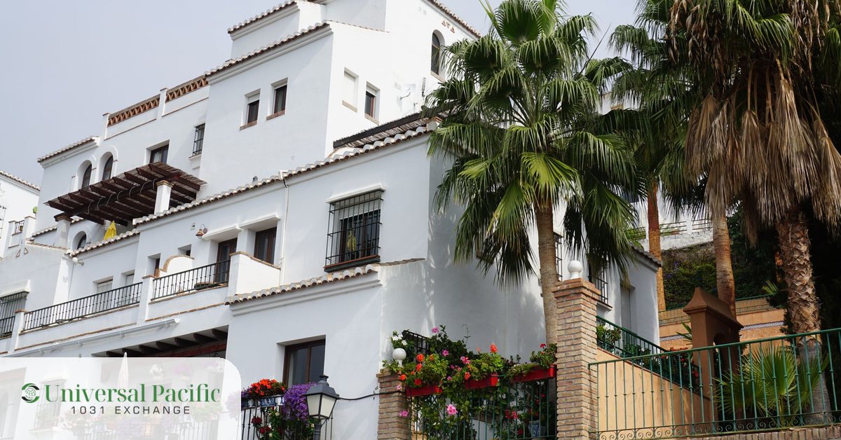 Whitewashed Mediterranean coastal villa with palm trees, an example of foreign property in a 1031 exchange